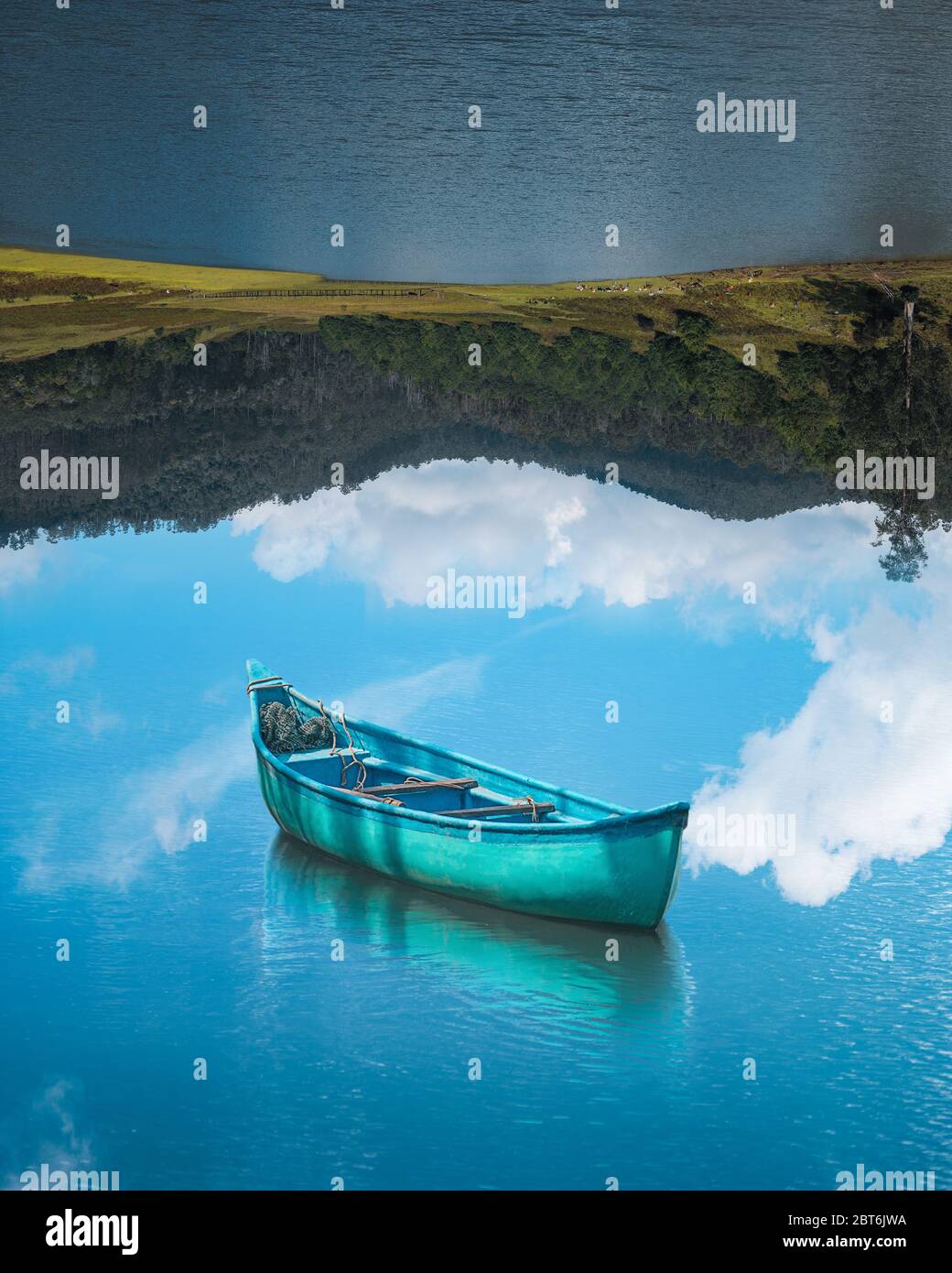 boat floating on reflection sky and lake upside down optical illusion