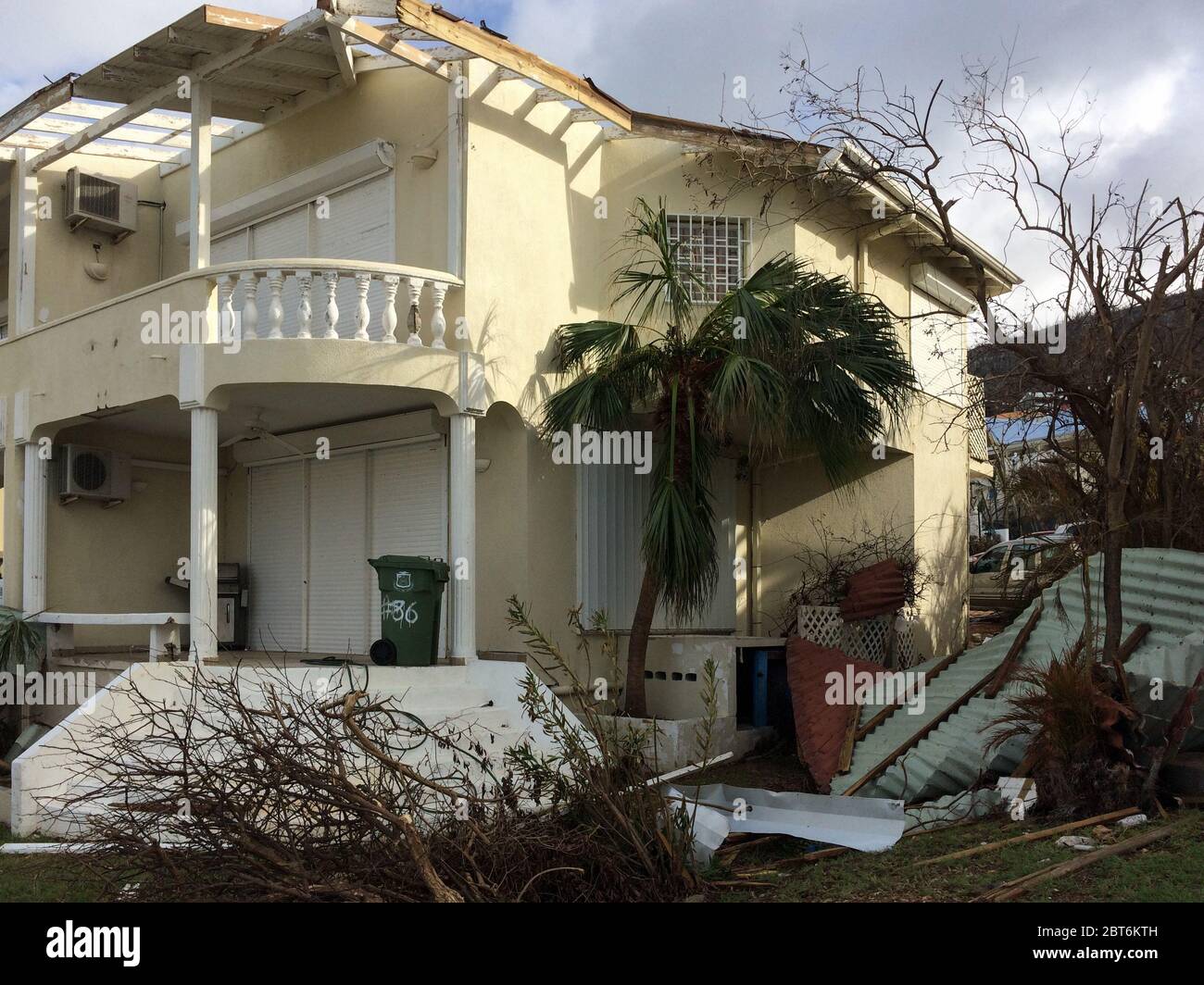 Debris after a category 5 storm: while shutters remained, Hurricane Irma took off most of the roof of this home in Sint Maarten causing major damage Stock Photo