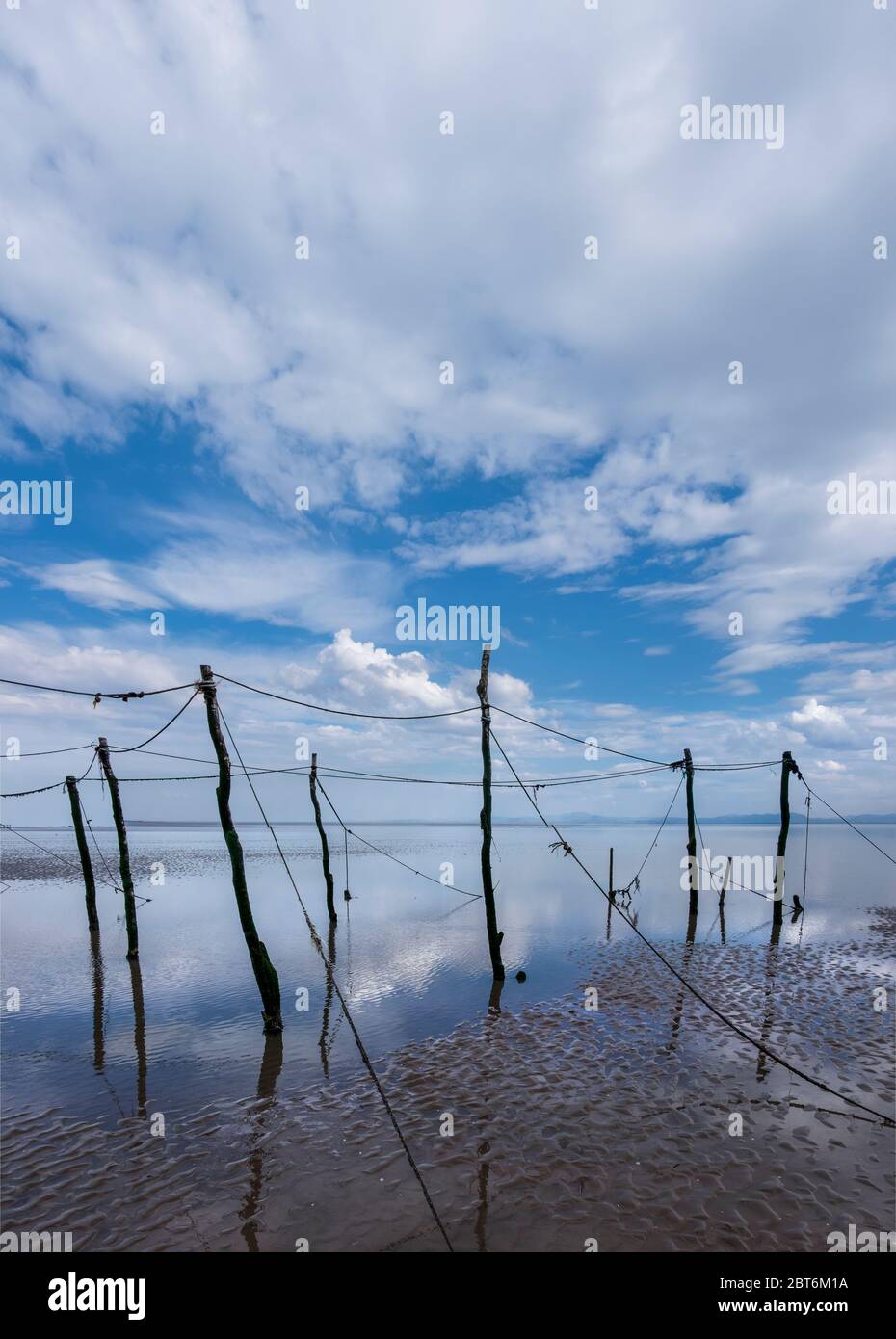 Sandyhills beach with disused salmon stake nets. Stock Photo