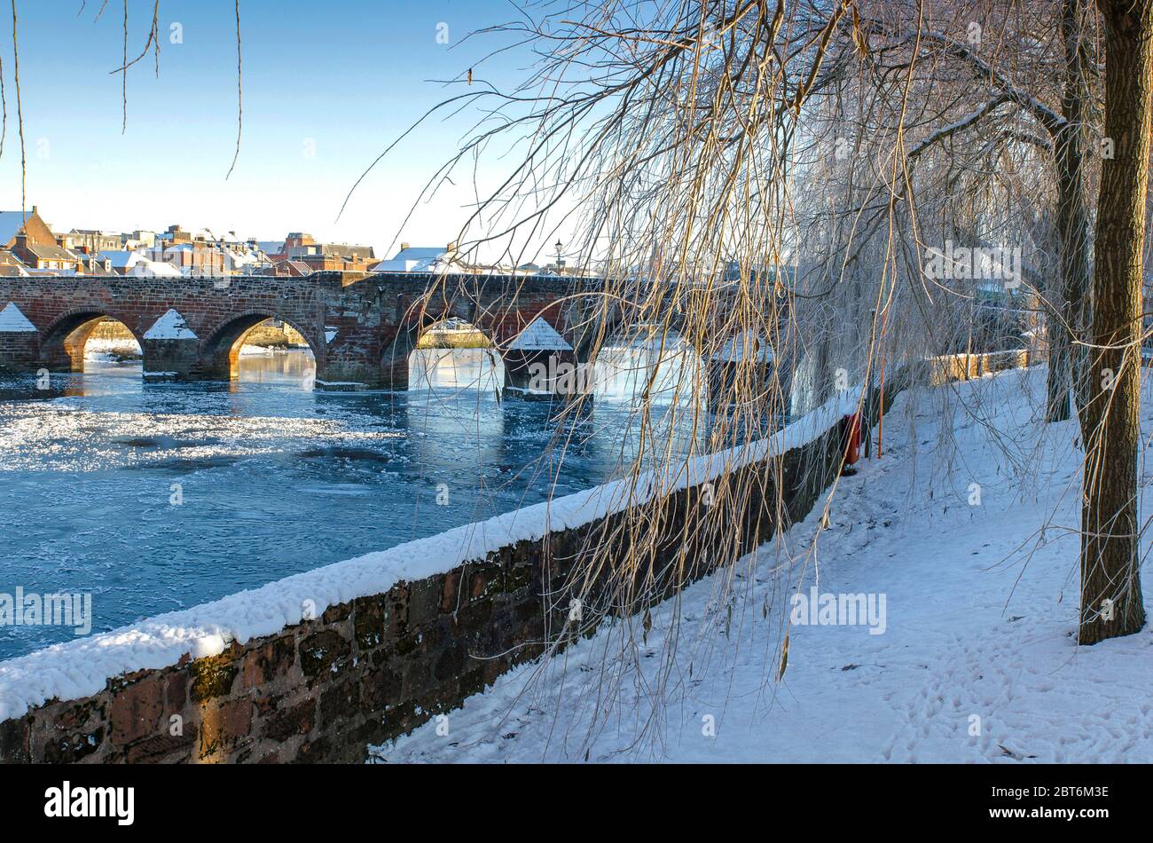 View of Auld Brig Dumfries Town and River Nith  in snowy winter conditions Stock Photo