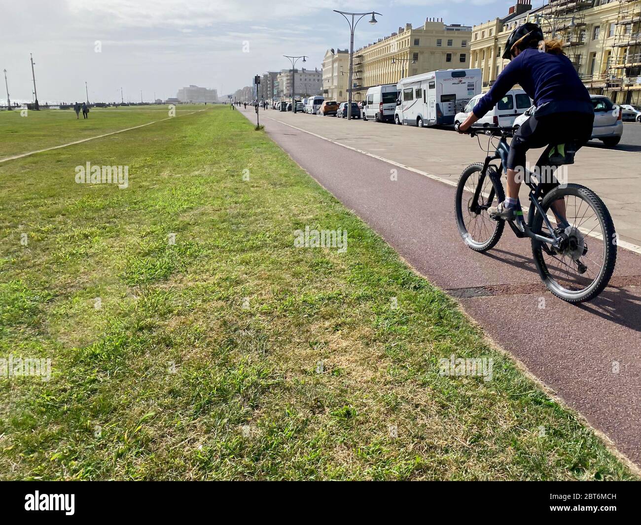 Woman cycling at speed on a bike path Stock Photo