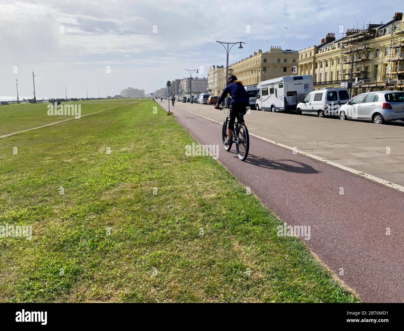 Person riding along a cycle path in the city Stock Photo