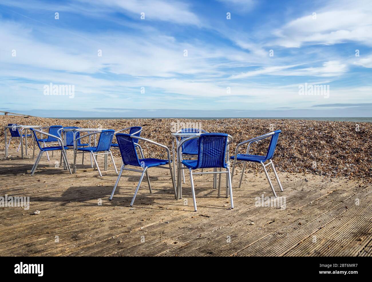 Beach cafe terrace, UK, deserted with no customers. Empty chairs. Stock Photo