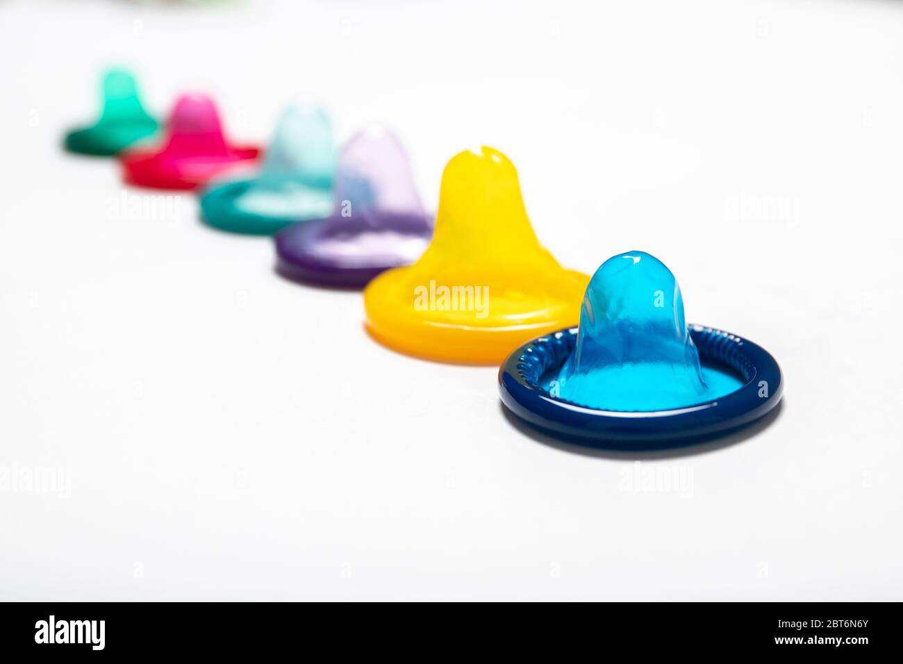 Multi-colored condom on a white background. Contraception. Safe sex Stock Photo