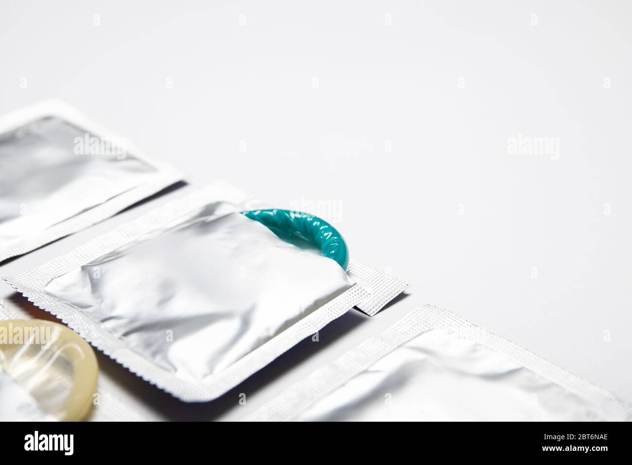Condoms on a white background. Colored condoms. Contraception Stock Photo