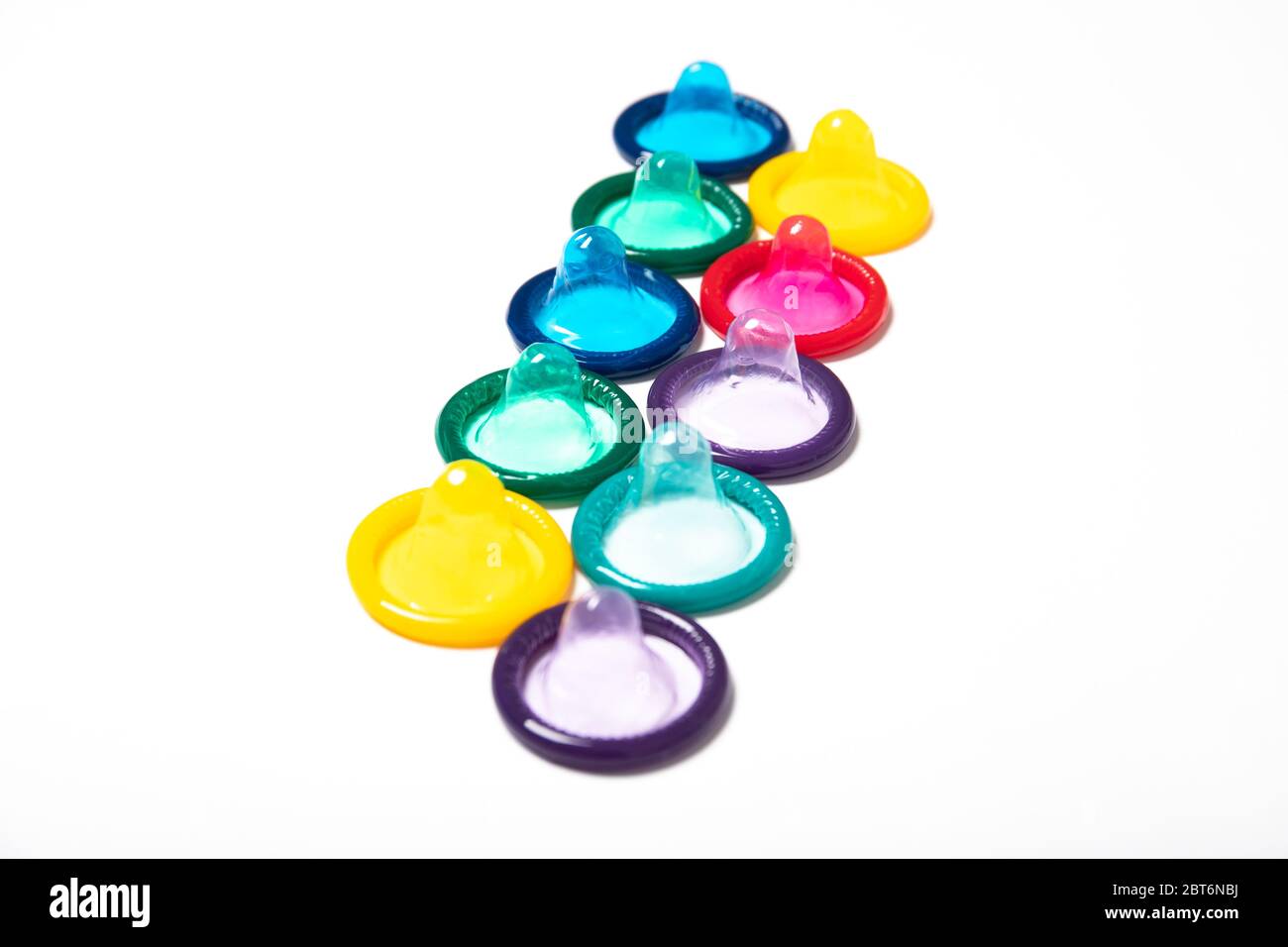 Colored condoms isolated on a white background. Contraception. Stock Photo