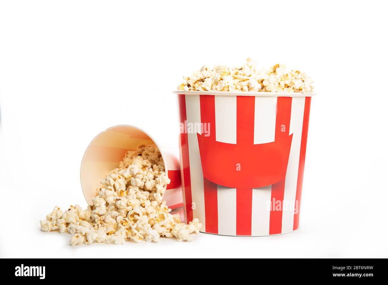 Paper cup with popcorn isolated on a white background. Stock Photo