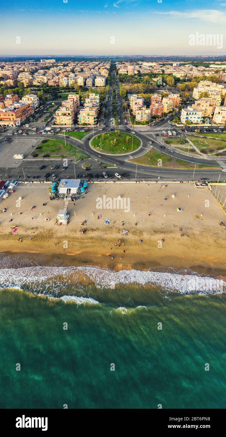 Aerial vertical panorama of Lido di Ostia famous Italian sandy beach and cityscape. Mediterranean resort for travel and vacations. Stock Photo