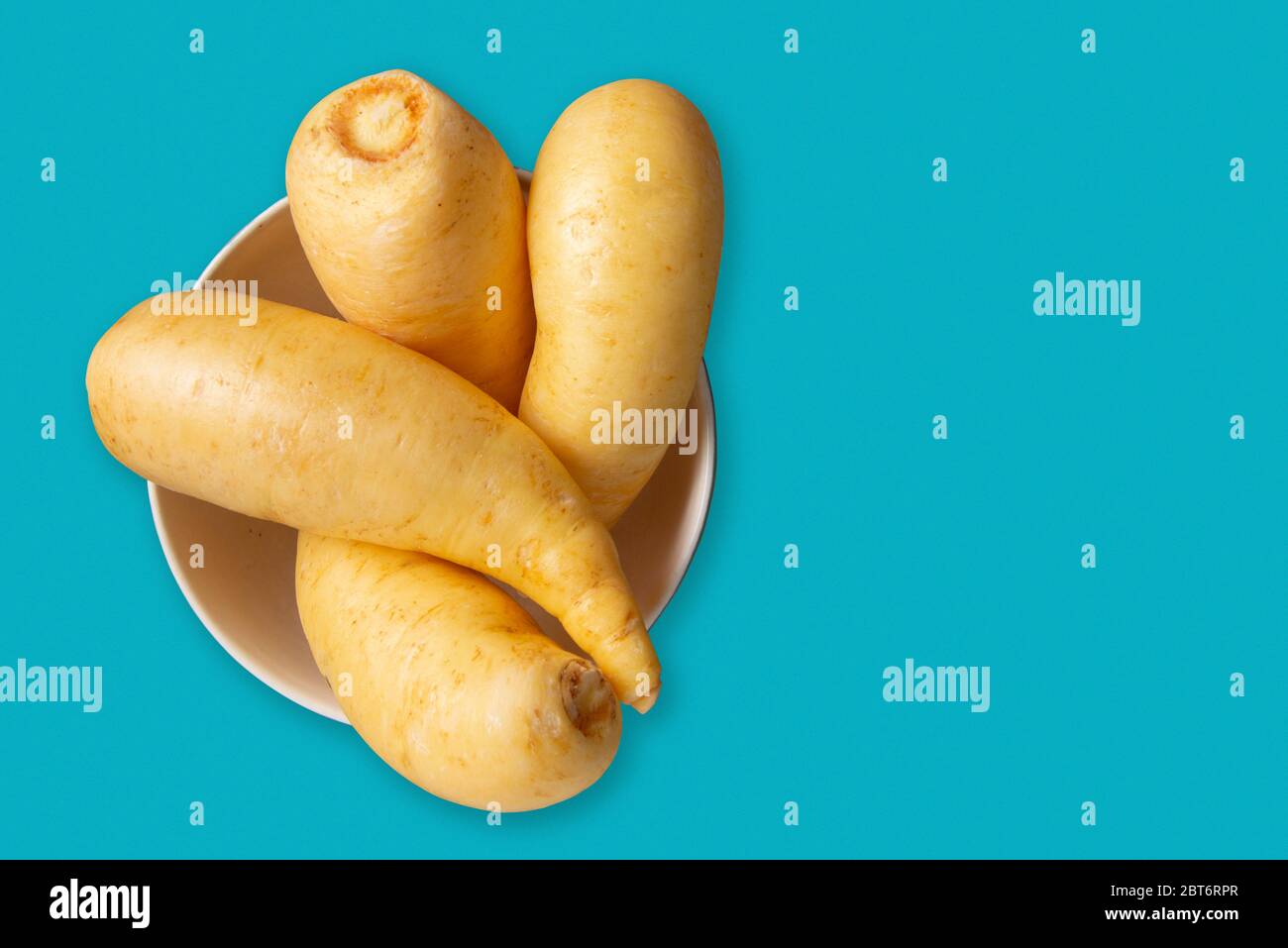 Potato salsa or baroa potatoes in the ceramic bowl. Top view and copy