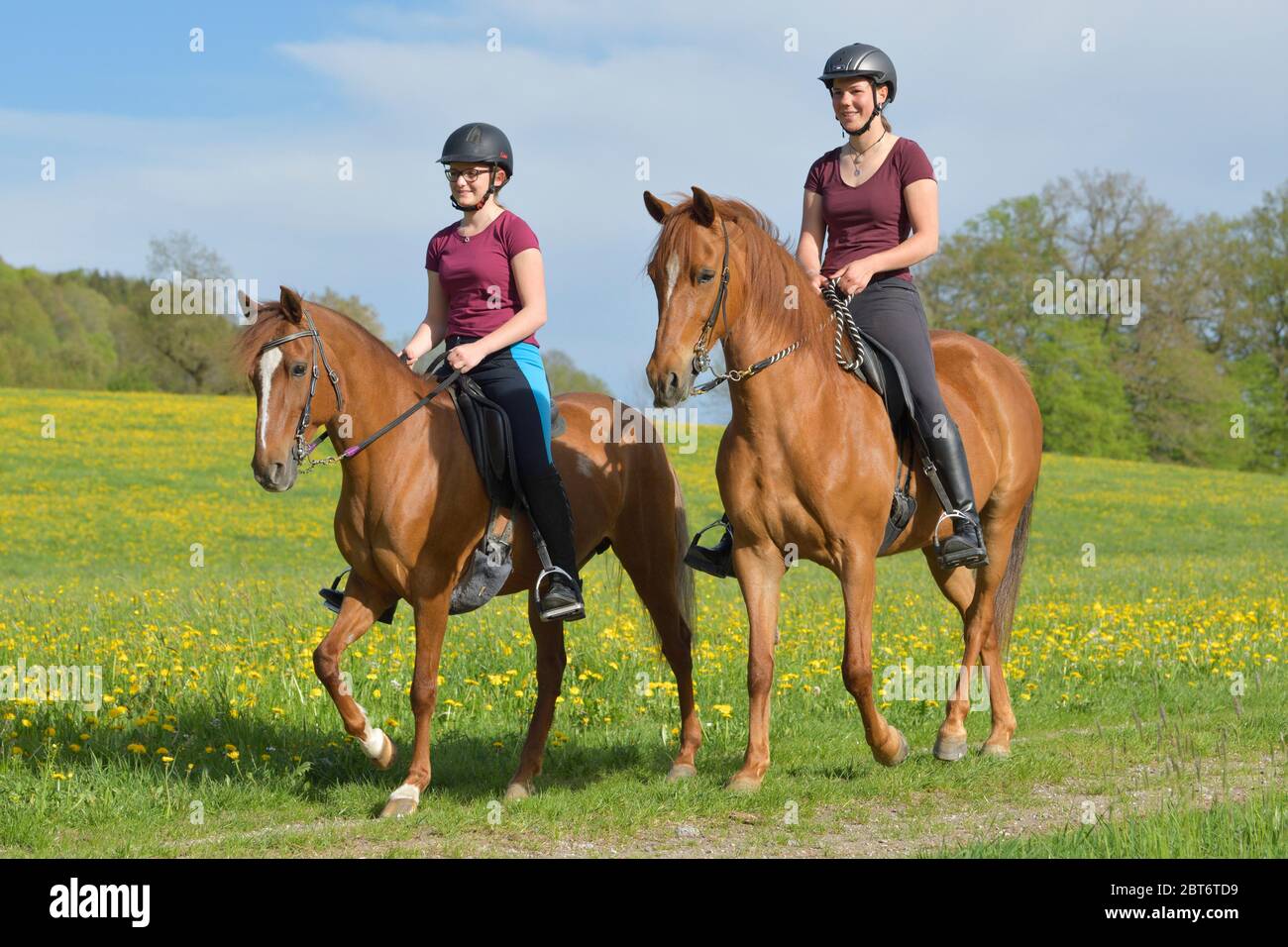 Two girls on horseback hi-res stock photography and images - Alamy