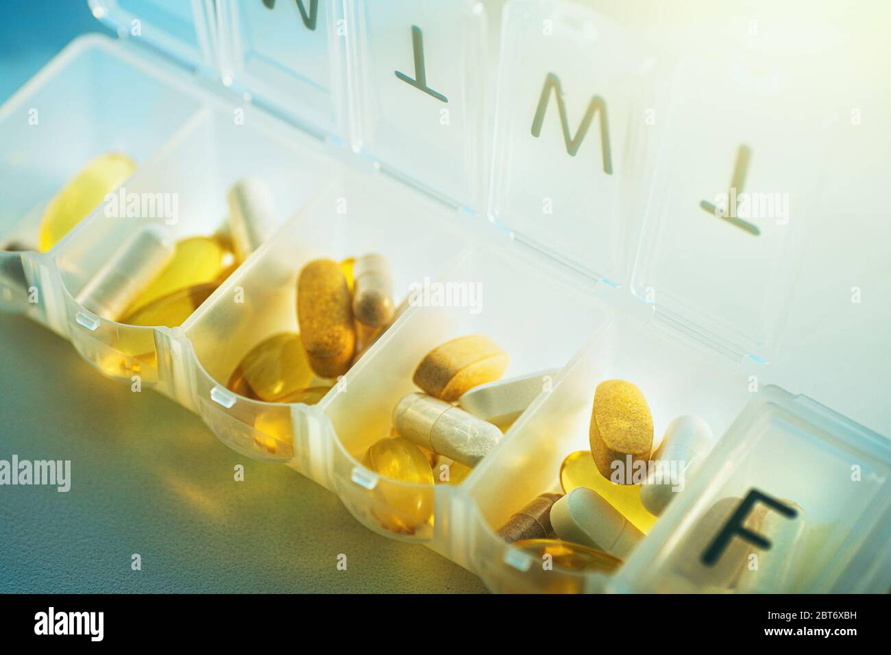 Daily pill organizer with drugs, tablets and dietary supplements. Pill