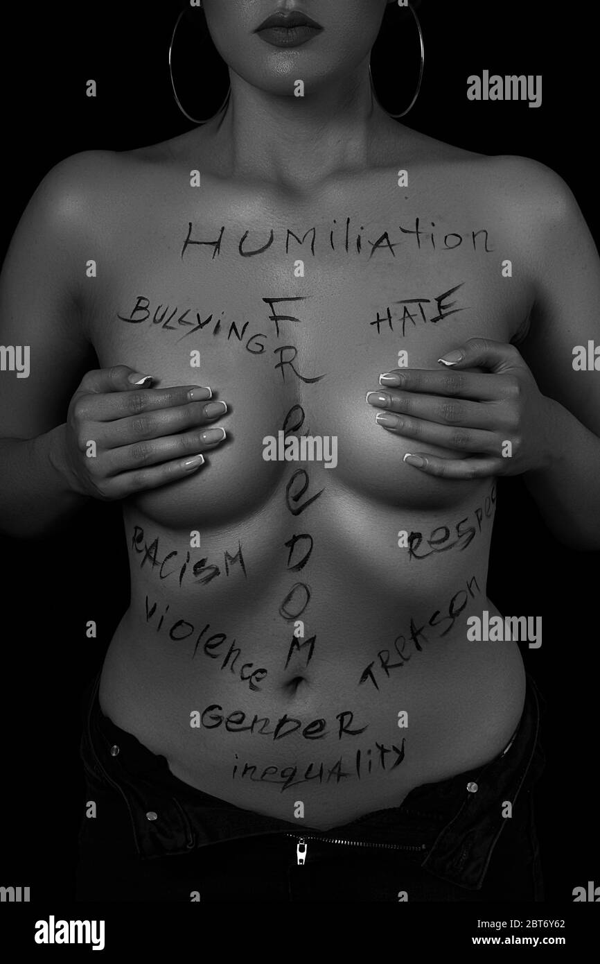 part of the body of a young girl with the inscription, humiliation,  bullying, freedom, racism, violence . the captions are written in the  photographer Stock Photo - Alamy