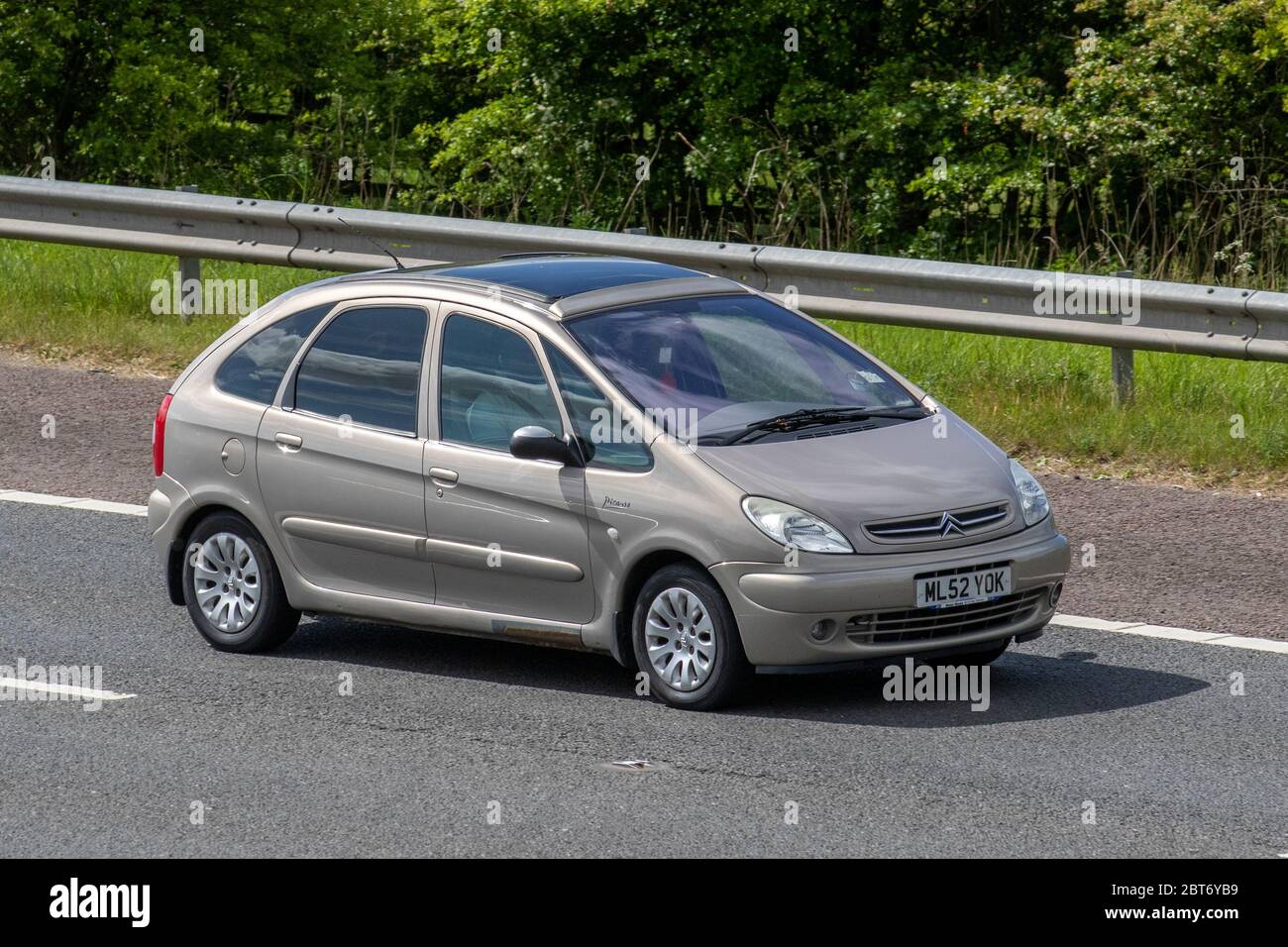 2002 beige Citroën Xsara Picasso Exclusive; Vehicular traffic moving vehicles, cars driving vehicle on UK roads, motors, motoring on the M61 motorway highway Stock Photo