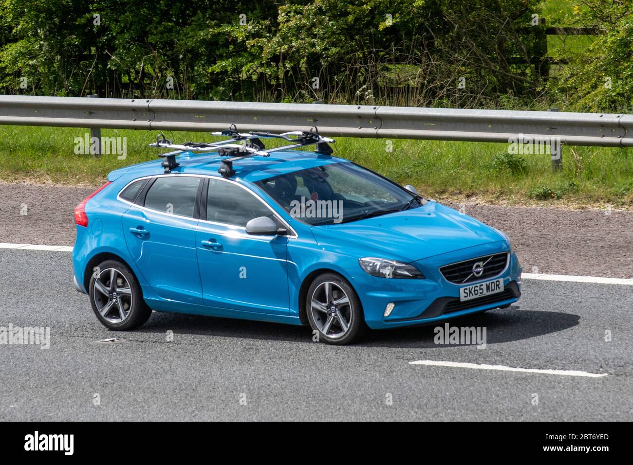 2015 blue Volvo V40 R-Design T2; Vehicular traffic moving driving vehicle on UK roads, motors, motoring on M61 highway Stock Photo - Alamy
