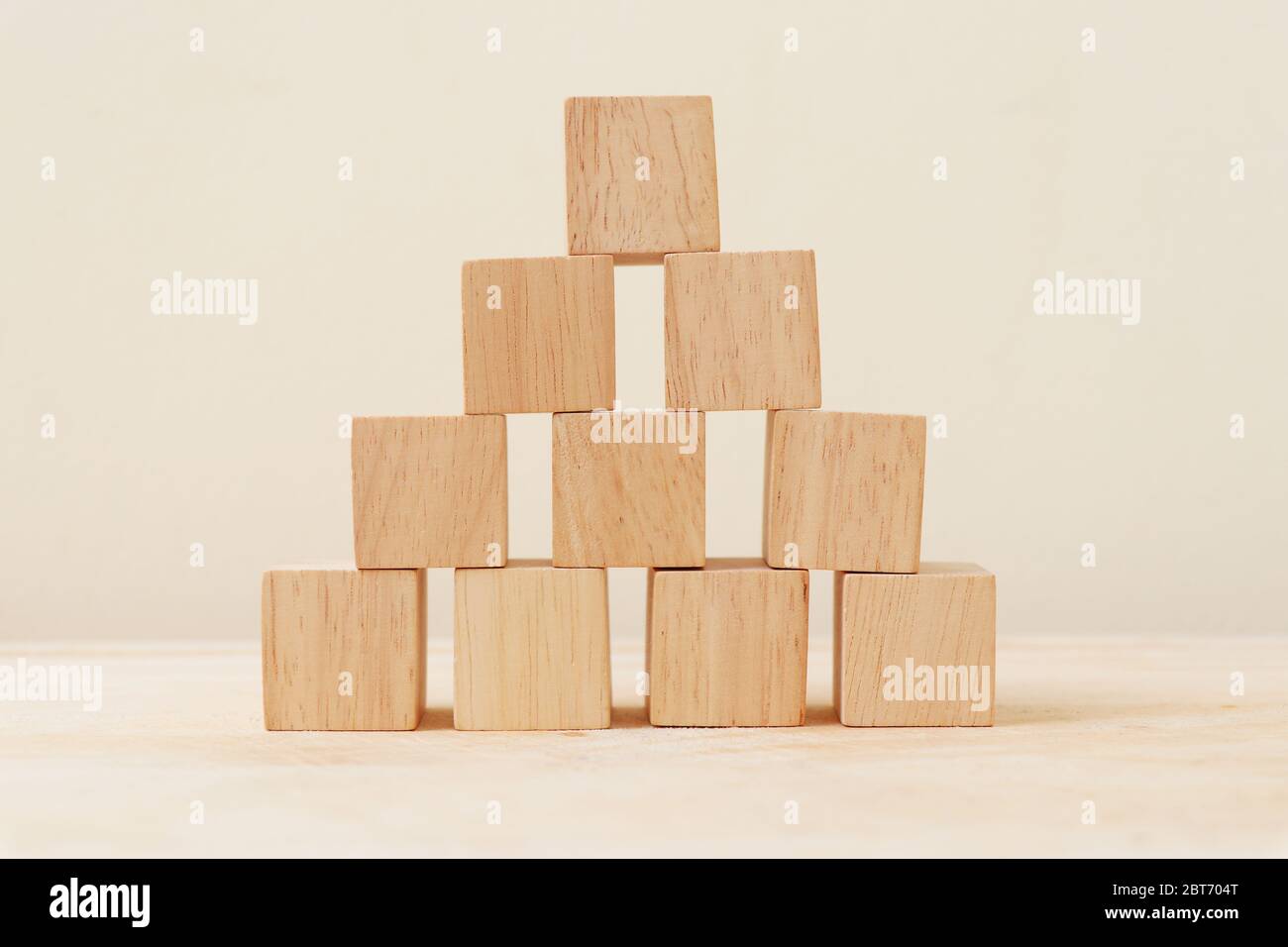 https://c8.alamy.com/comp/2BT704T/wooden-cube-stacked-into-a-pyramid-2BT704T.jpg