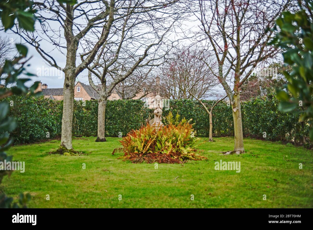 Rear view of Greywalls hotel and gardens with central statue amongst shrubbery, Gullane, East Lothian, Scotland, UK Stock Photo