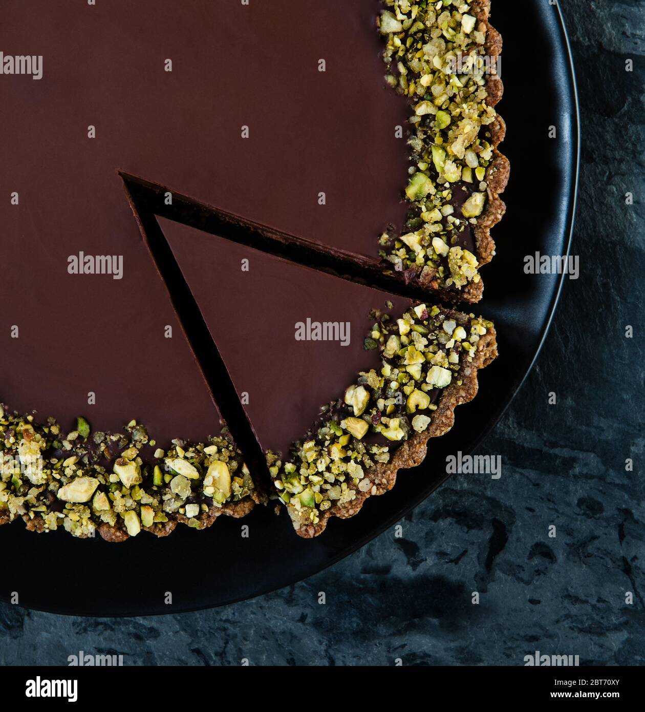 dark chocolate tart with pistachio topping Stock Photo Alamy