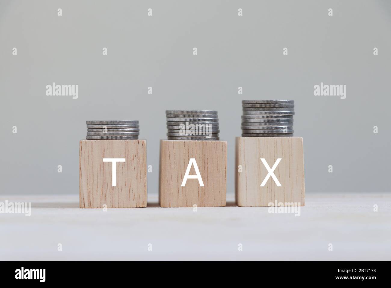 Tax with coins arranged in bar graphs on top. Stock Photo