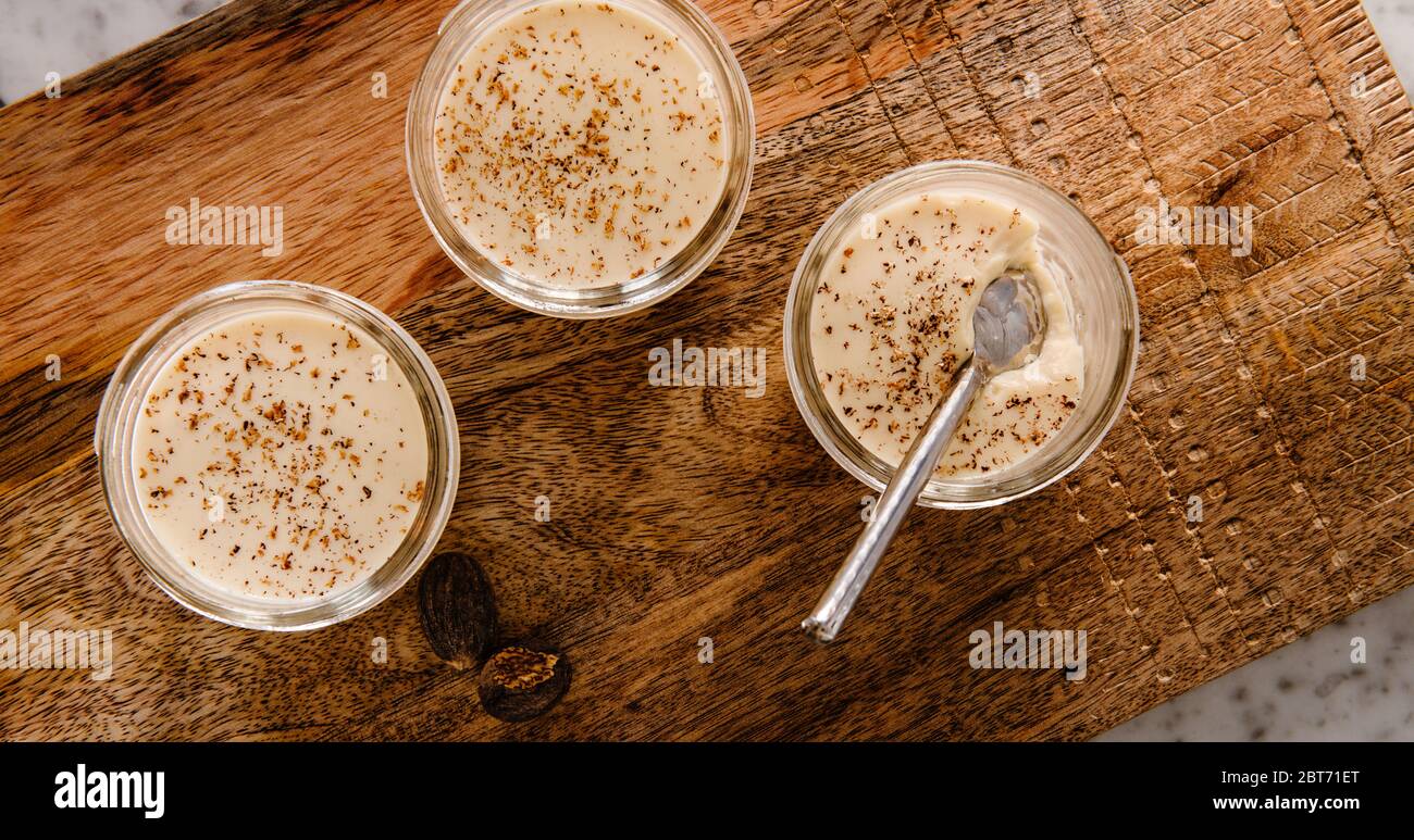 Vanilla custard pudding with nutmeg on a wooden serving board Stock Photo
