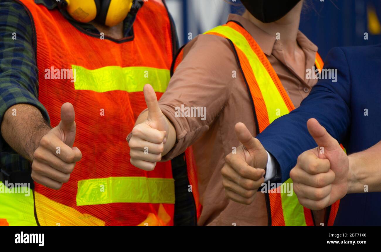 4 Industrial workers or engineers Thumbs up Stock Photo