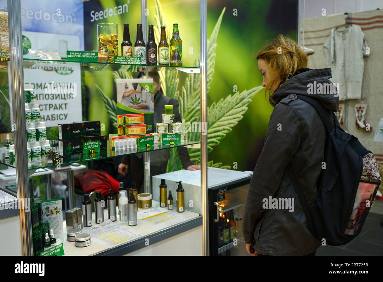 Customer and sales manager standing in front of a counter with cannabis products and communicating. November 10, 2019. Kiev, Ukraine Stock Photo