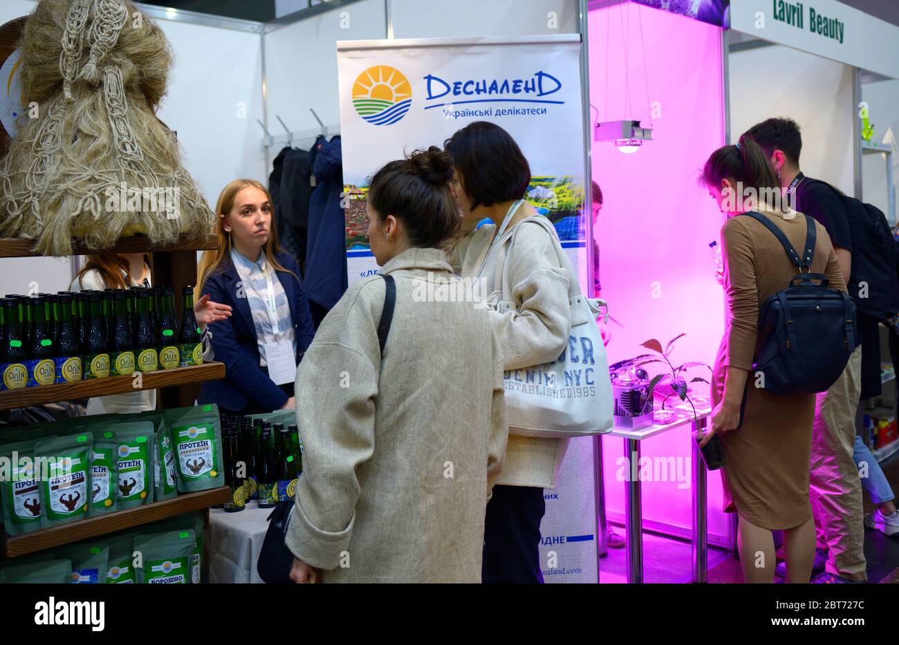 Customer and sales manager standing in front of a counter with cannabis products and communicating. November 10, 2019. Kiev, Ukraine Stock Photo