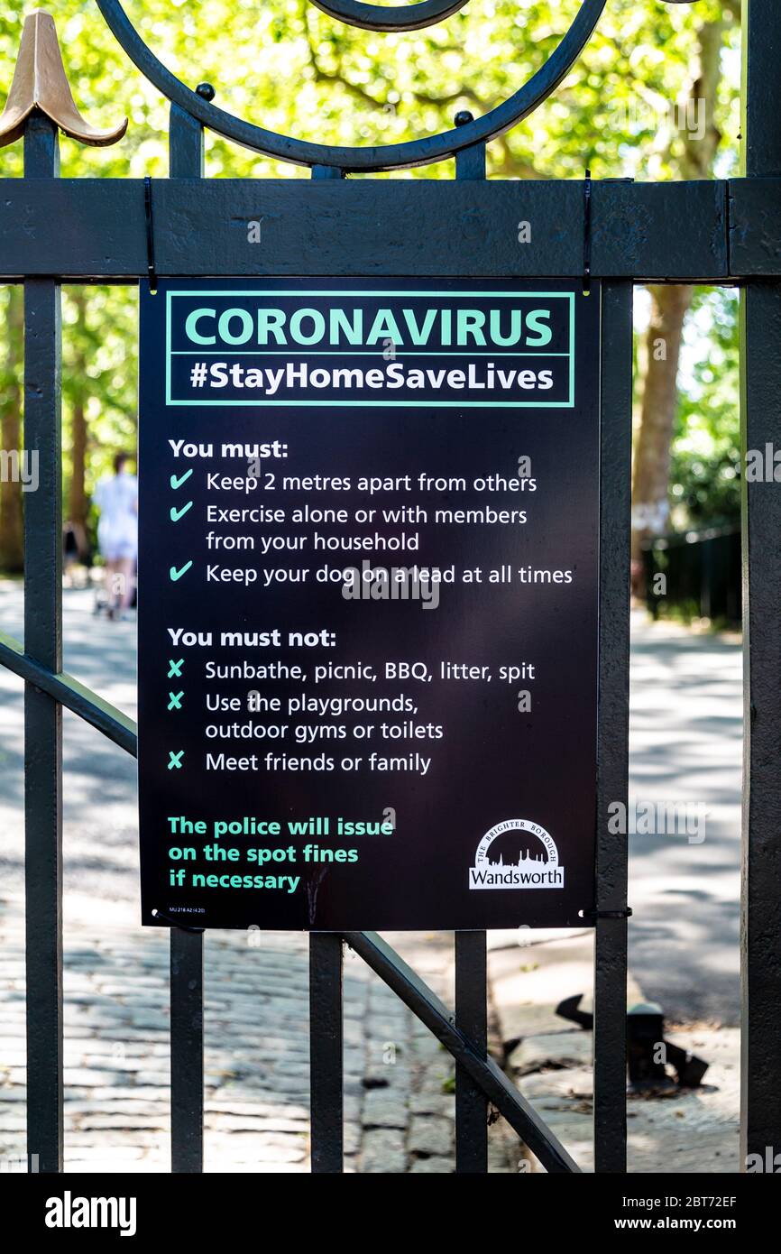 21 May 2020, London, UK - Sign with social distancing guidelines during the Coronavirus pandemic lockdown on the gate of Battersea Park Stock Photo