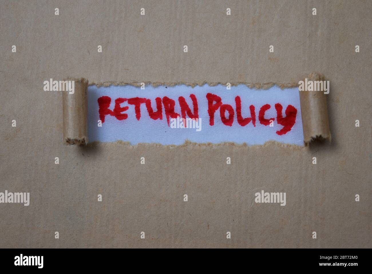 Return Policy Text written in brown torn paper Stock Photo Alamy
