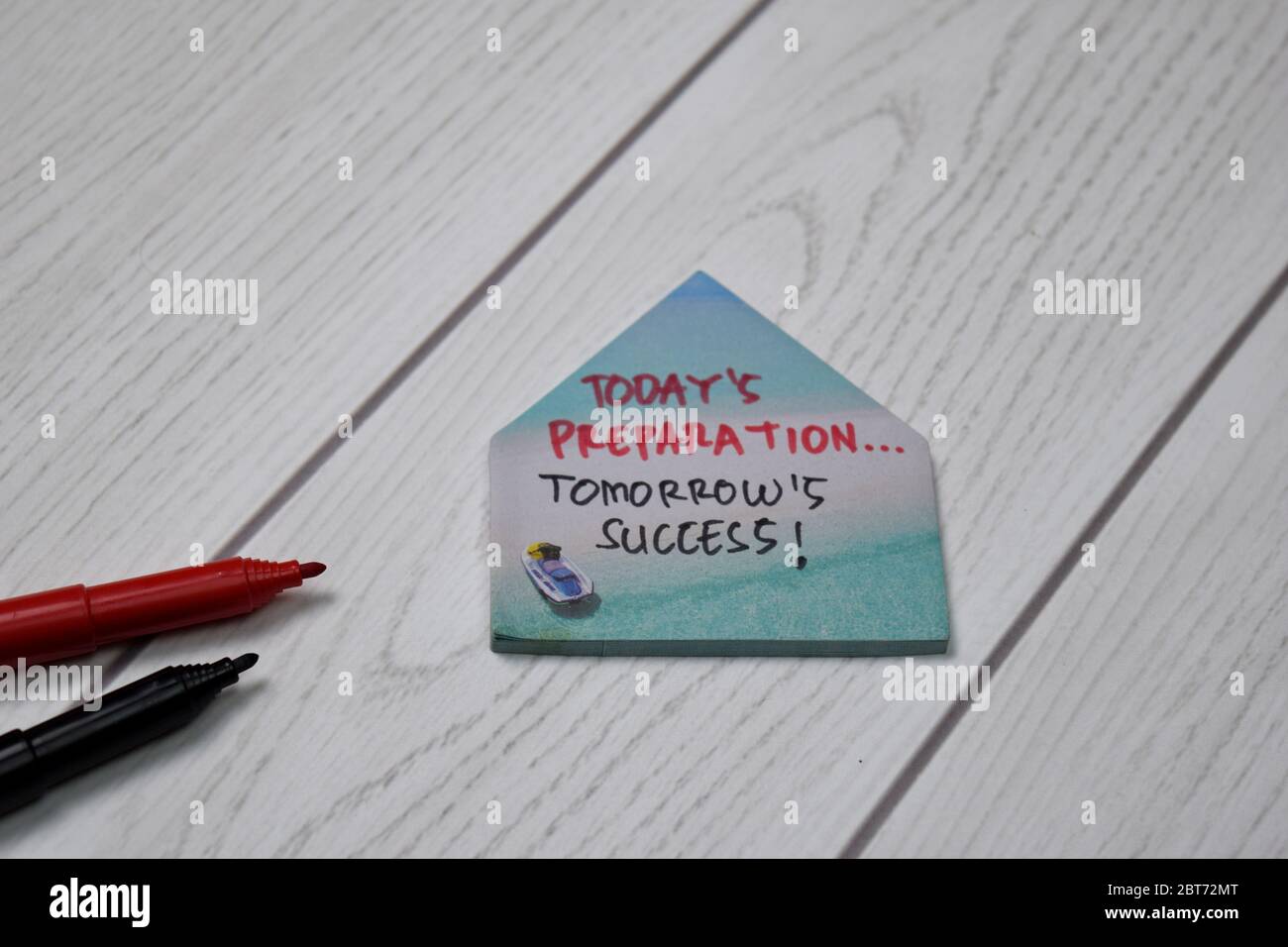 Today's Preparation, Tomorrow Success! write on sticky note isolated on wooden table. Stock Photo