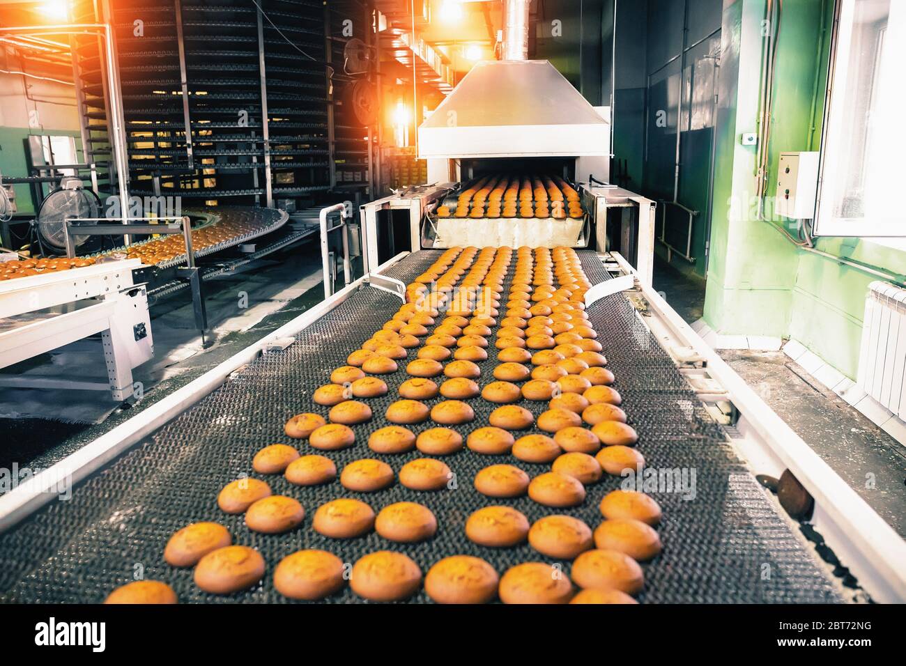 Bakery production line with sweet cookies on conveyor belt in