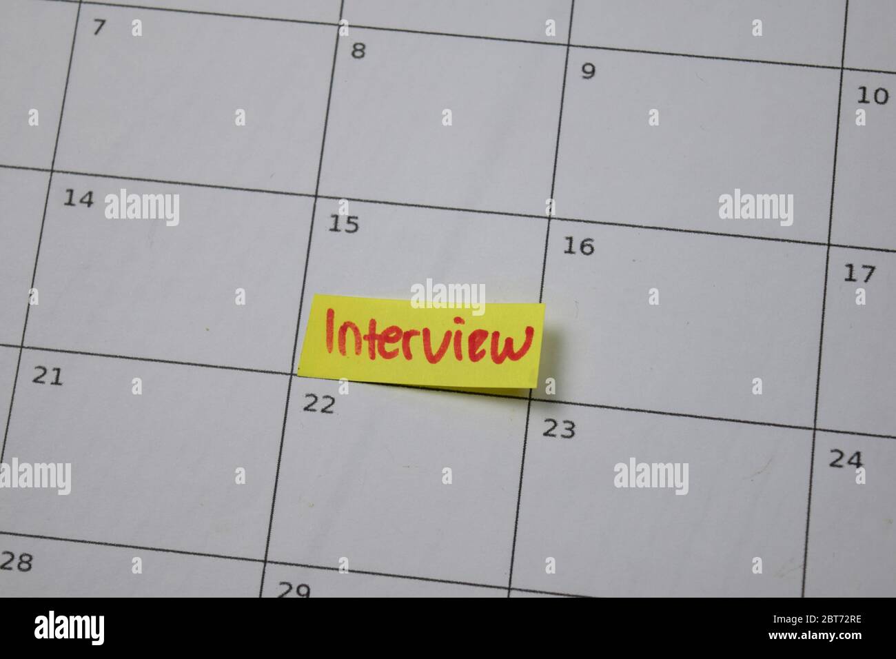 Interview on monthly Calendar and marked 15th isolated on office desk Stock Photo