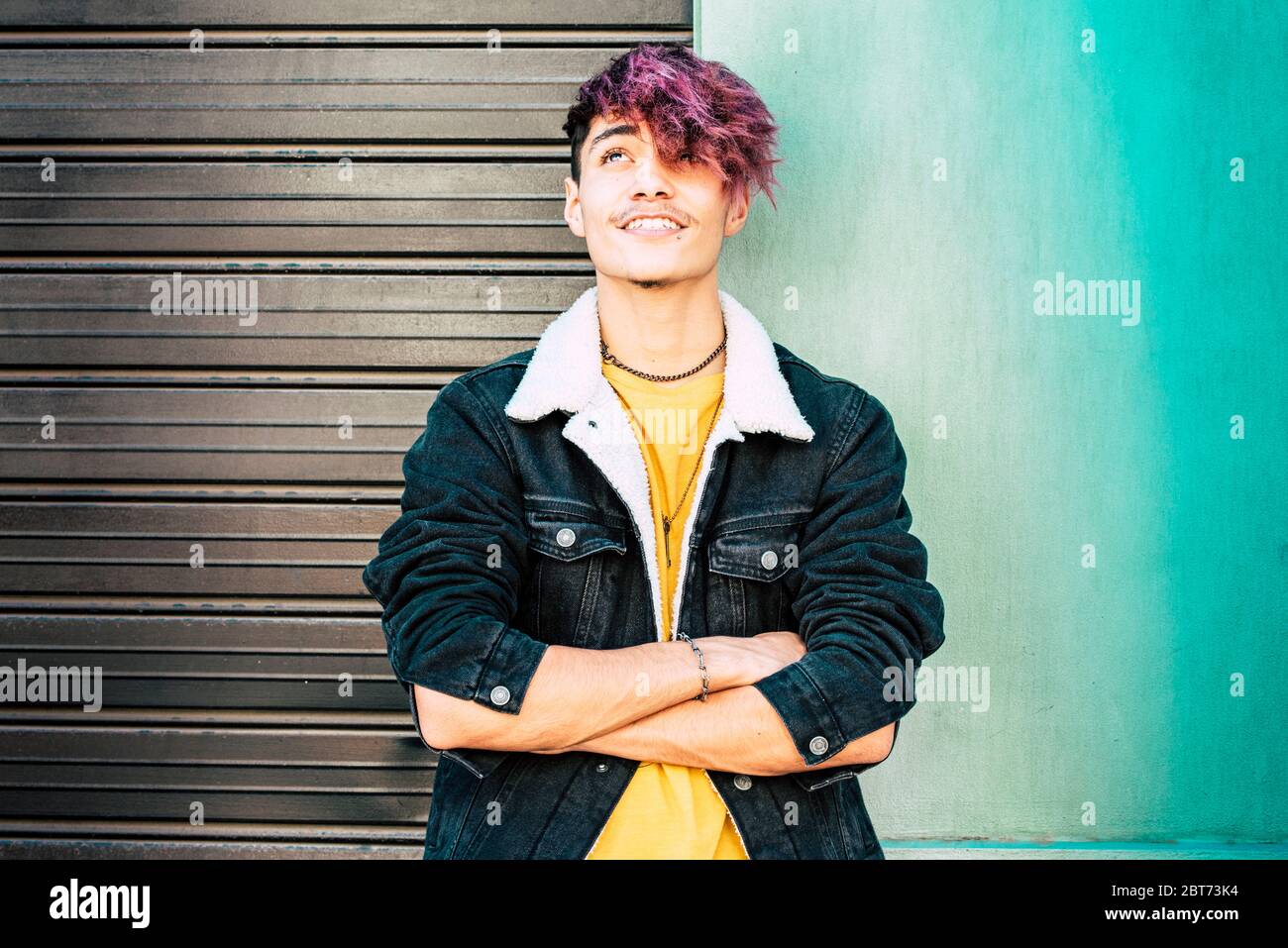 Portrait of young teenager alternative boy and colorful clothes and wall  background - urban people and diversity hair coloured concept - youthful  and Stock Photo - Alamy