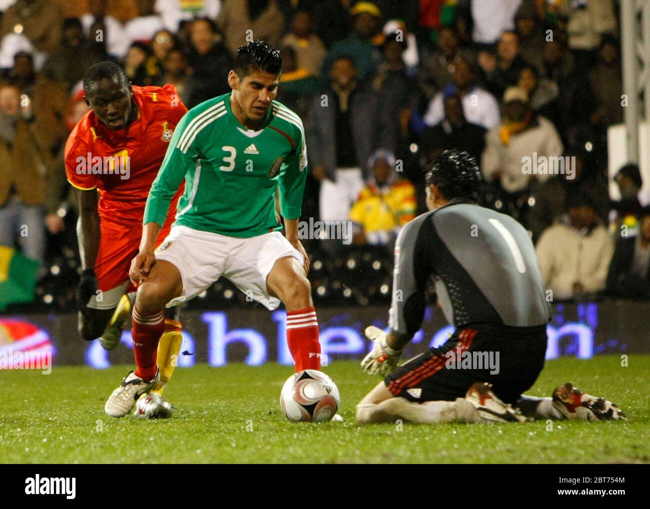 LONDON, UK. MARCH 26: Mexico's Carlos Salcido sees the ball safely back to his keeper Oswaldo Sanchez during International Friendly between Mexico Cit Stock Photo