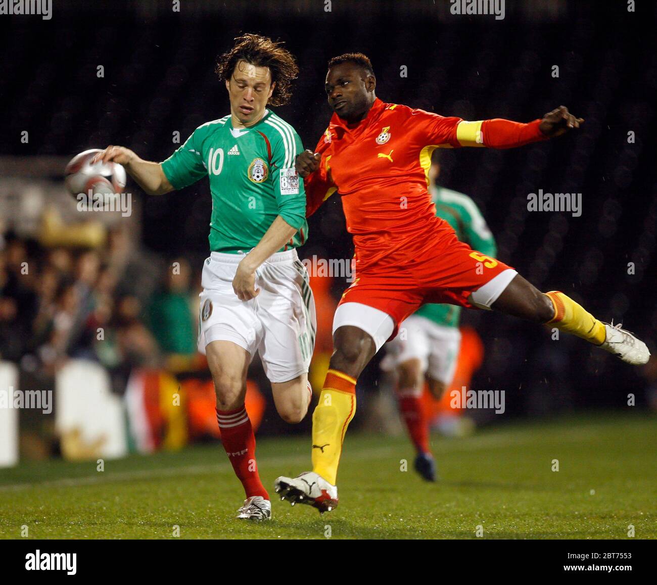 LONDON, UK. MARCH 26: Mexico's Antonio De Nigris in action against Ghana's John Mensah  during International Friendly between Mexico City and Ghana at Stock Photo