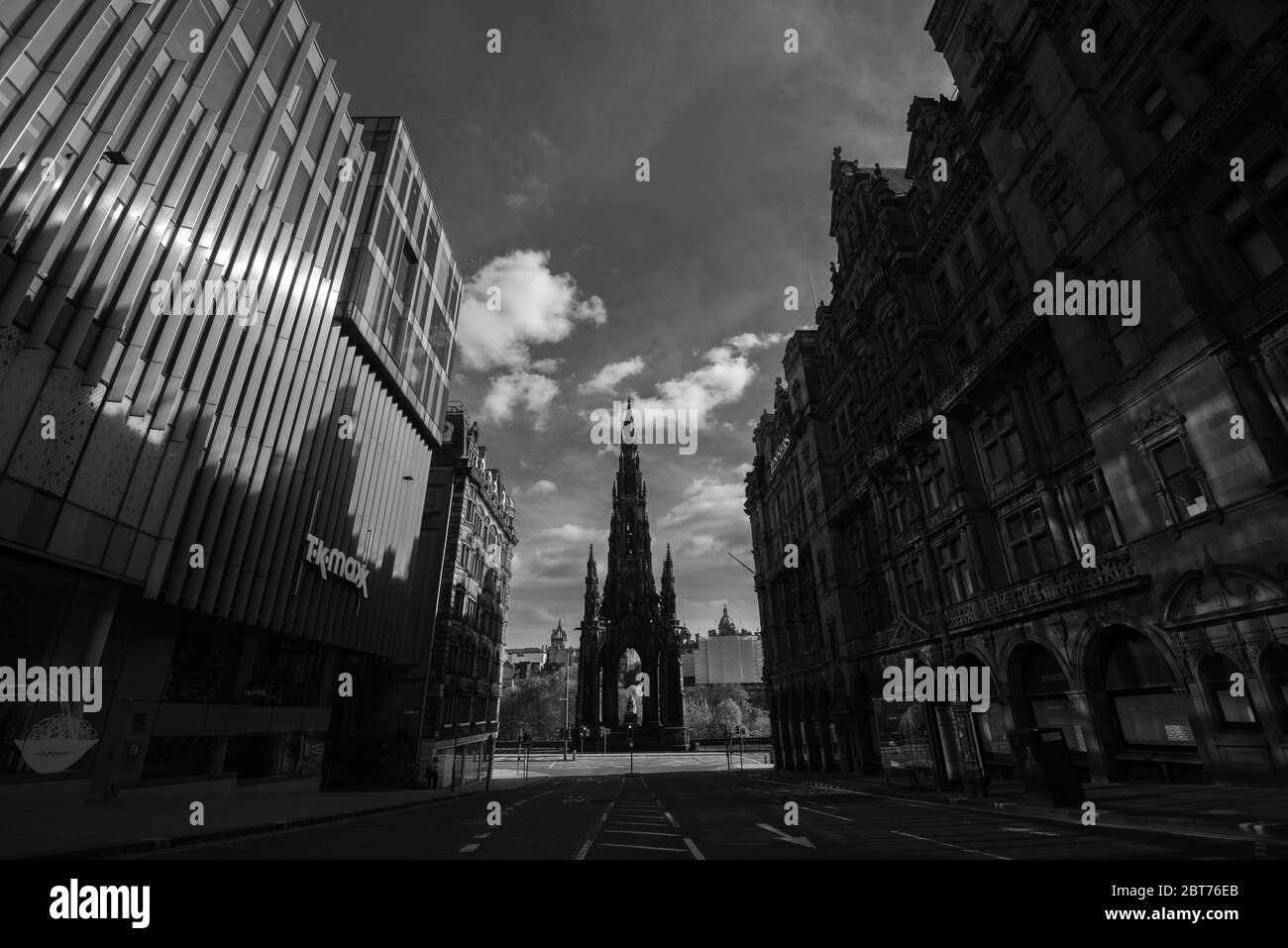 The Scott Monument Edinburgh from St David Street with modern building with mirrored windows to side. Black and white shot, taken lockdown 2020. Stock Photo