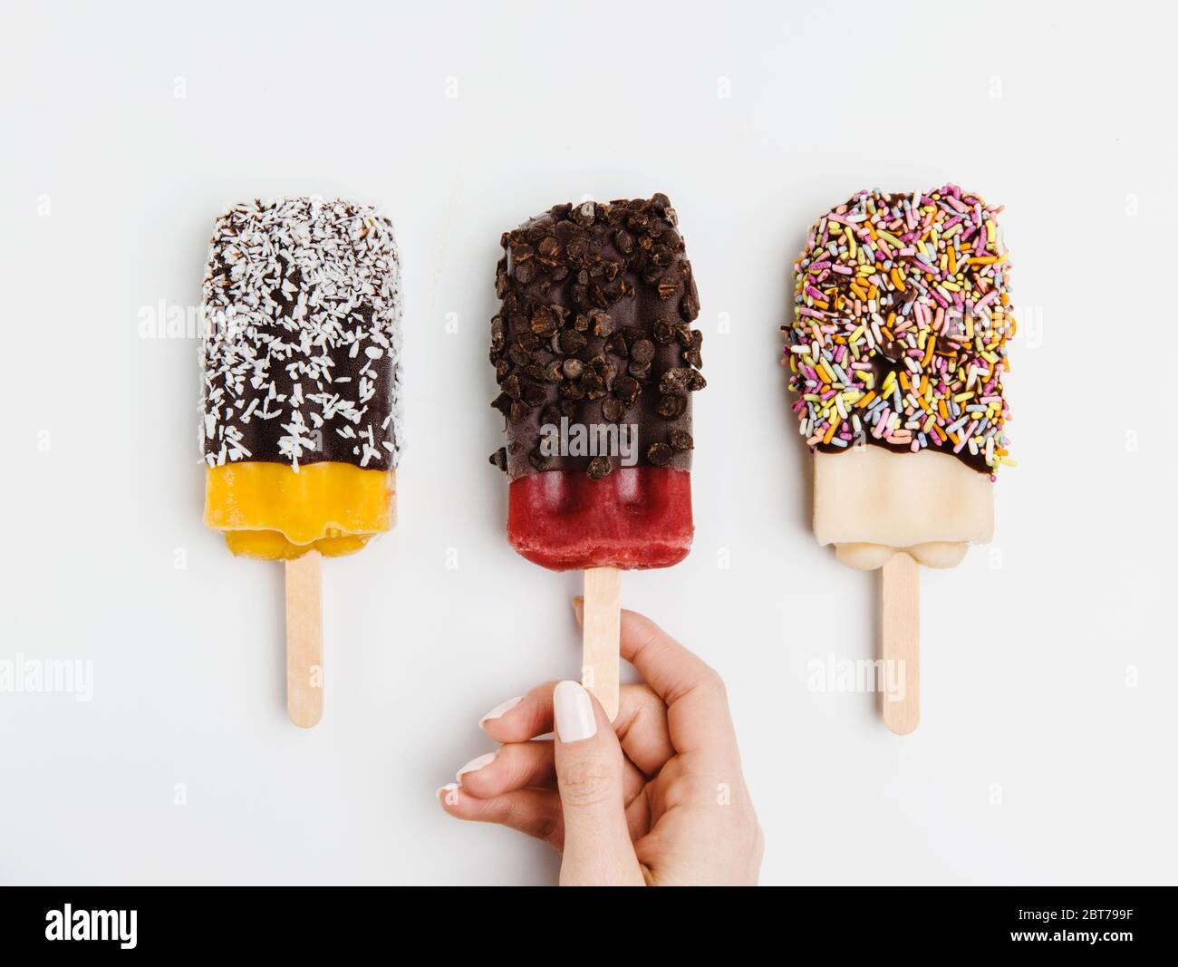 Assorted popsicles dipped in chocolate, coconut, sprinkles and chocolate chips Stock Photo