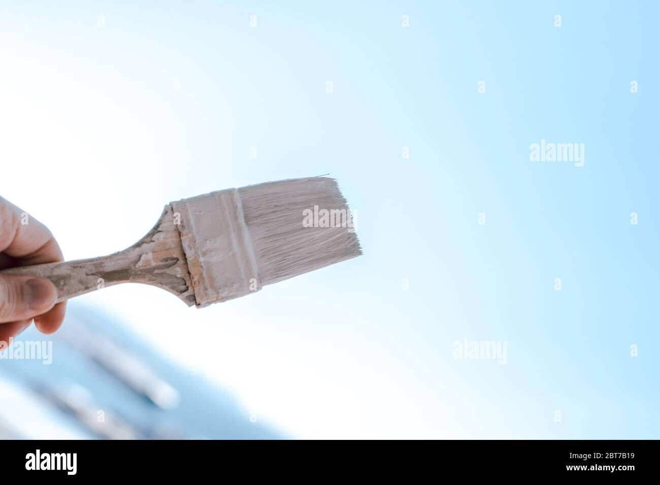 Paint brush with white paint against the sky Stock Photo Alamy