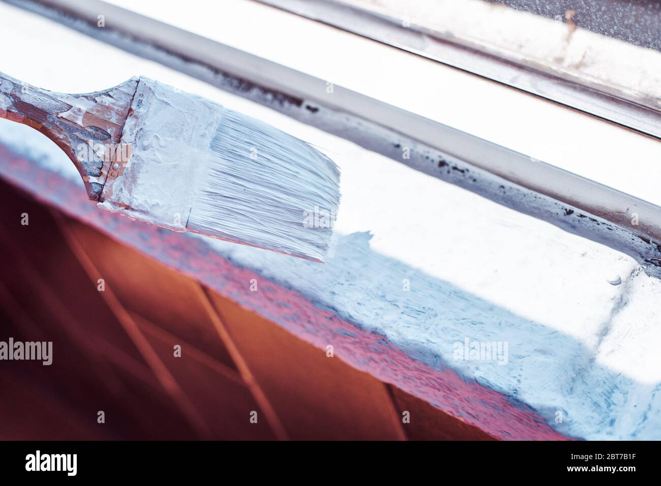 Paint brush with white paint over a wall Stock Photo Alamy