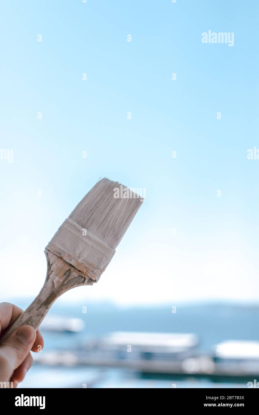 Paint brush with white paint against the sk Stock Photo Alamy