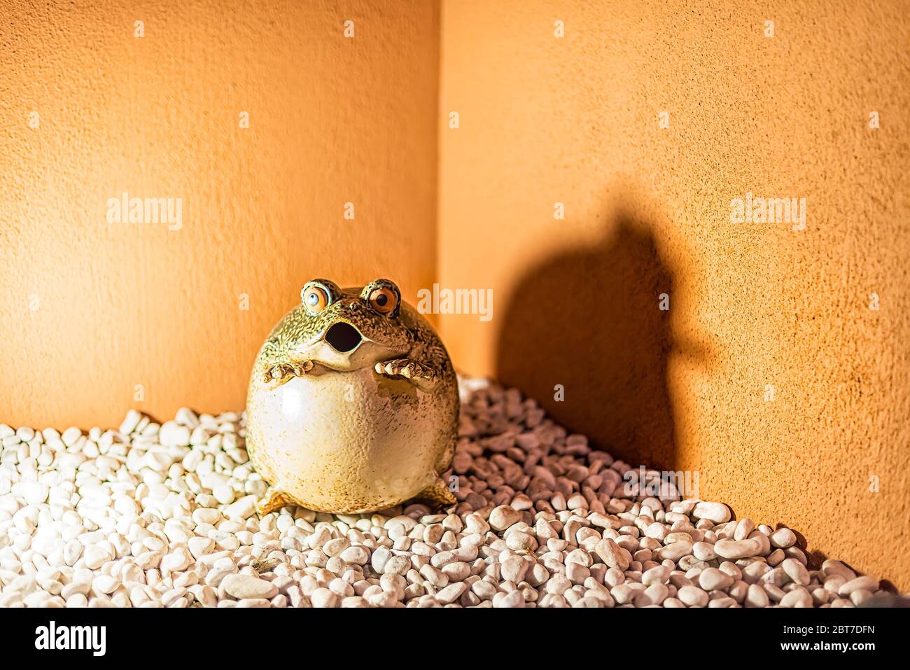 Kyoto, Japan - April 16, 2019: Night evening in Pontocho alley with traditional garden house and statue sculpture toad in rock gravel by wall funny hu Stock Photo