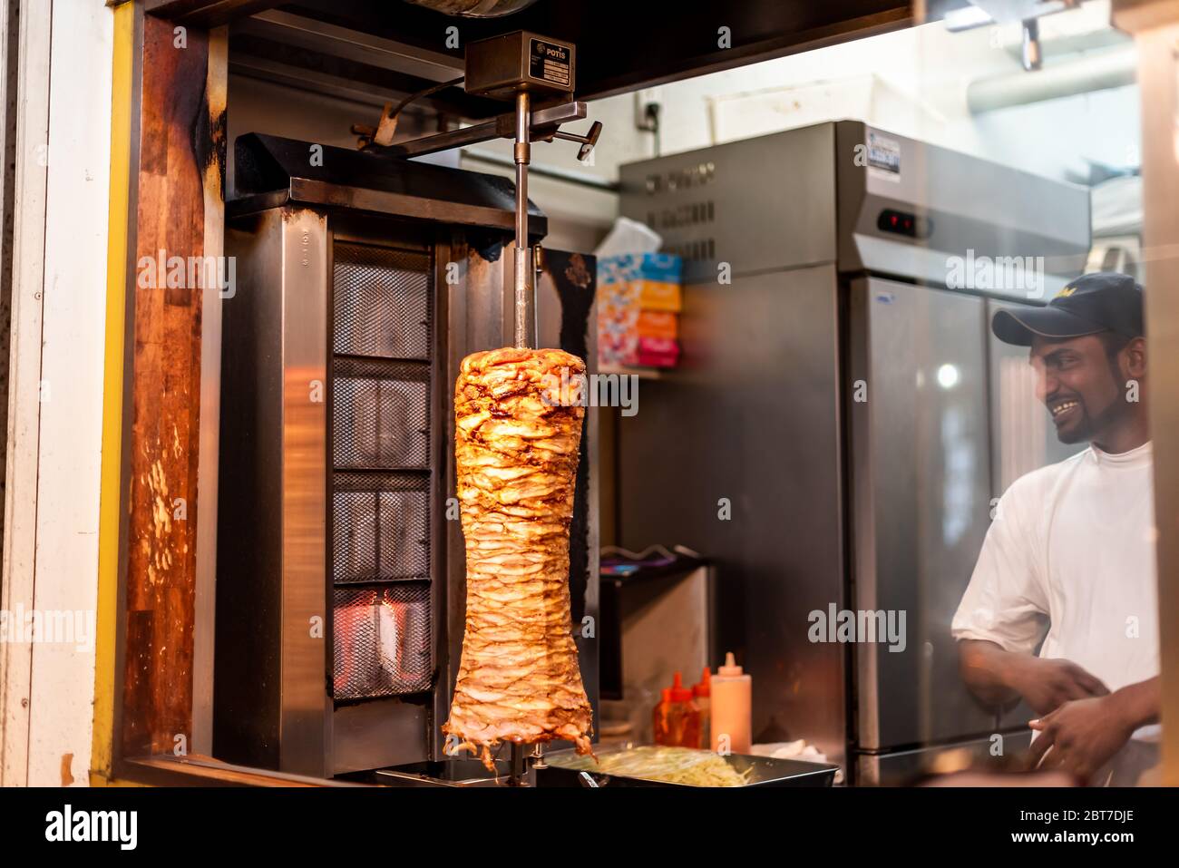 Tokyo, Japan - April 3, 2019: Shinjuku ward downtown with kebab shop restaurant counter entrance exterior street food with man foreigner chef Stock Photo