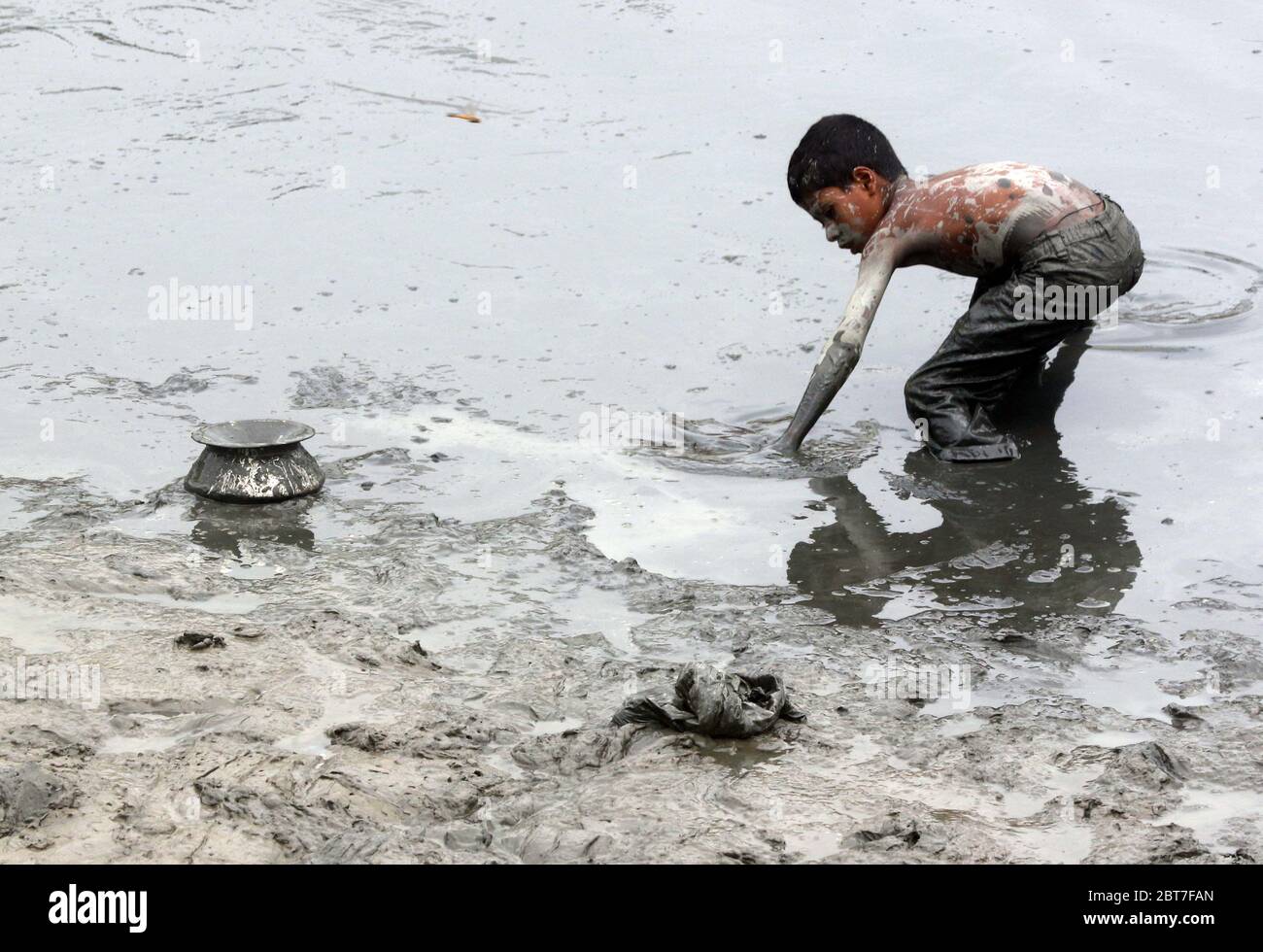 Dhaka 23 April 2015.A village boy catching fish in a river at savar in Dhaka.photo by leadfoto Stock Photo