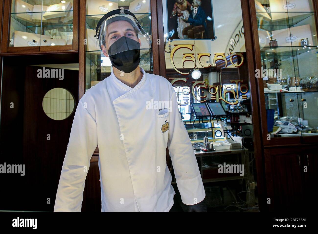 Andrea Pansa, owner of Pansa Cafè is at work wearing protective mask and visor. Italy begins a staged end to a nationwide lockdown due to the spread of the coronavirus disease, allowing the re-opening of all activities except schools and the mobility of citizens. Stock Photo
