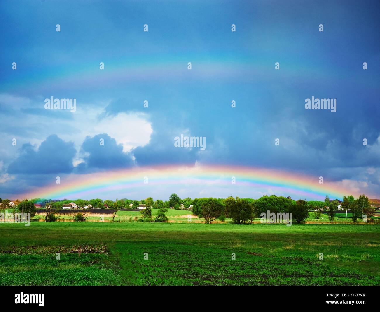double rainbow after a thunderstorm over a green field Stock Photo - Alamy