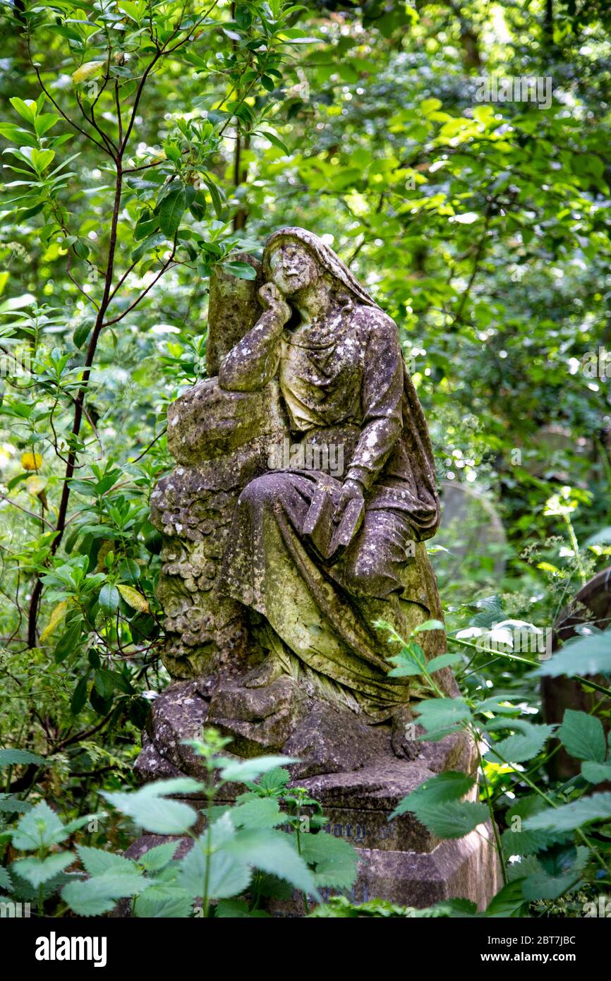 Funerary monument, statue of a sad, mourning, wistful woman, Abney Park Cemetery, London, UK Stock Photo