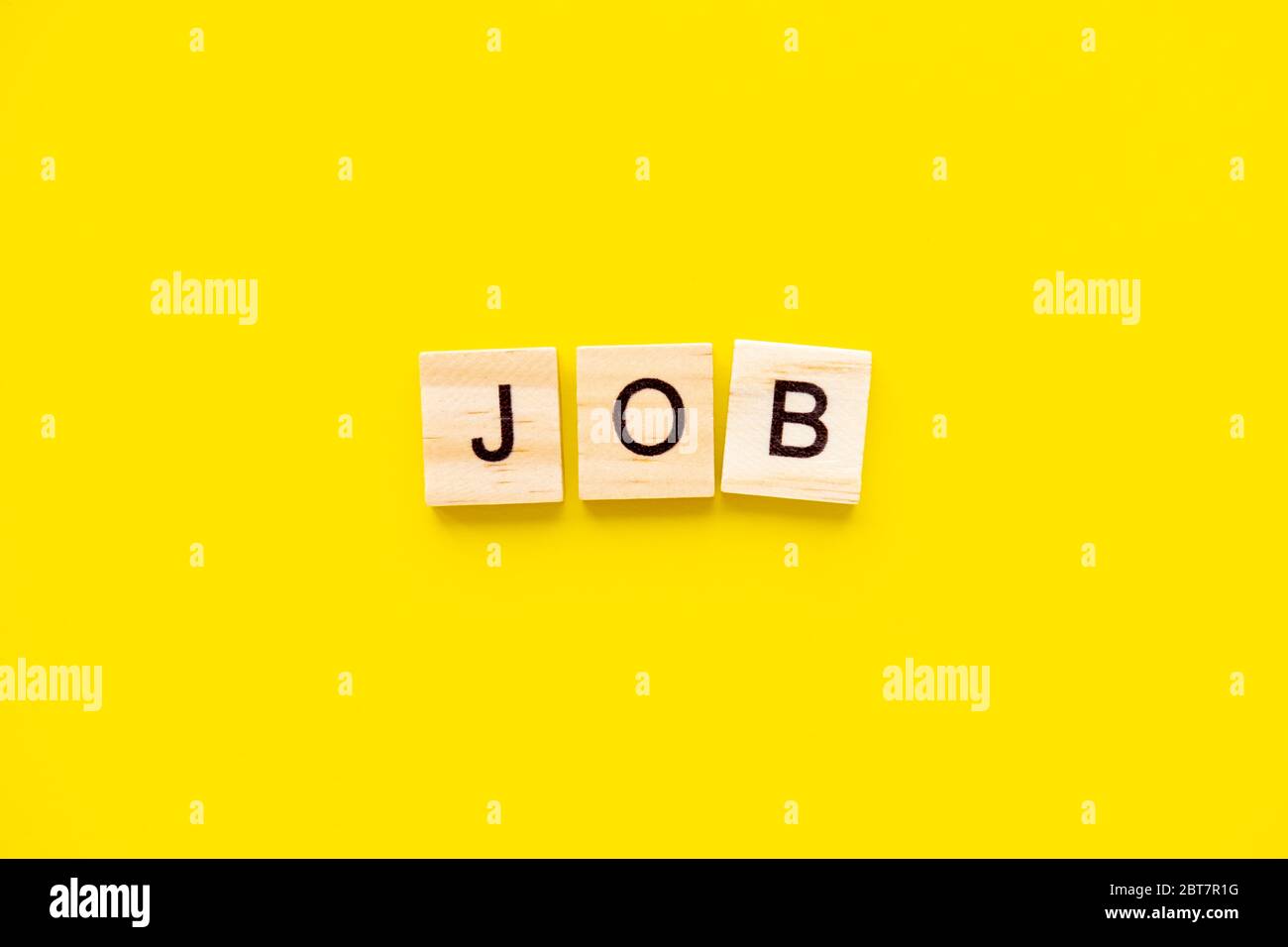 word job. Wooden blocks with lettering on top of yellow background. Human Resource Management and Recruitment and Hiring concept Stock Photo