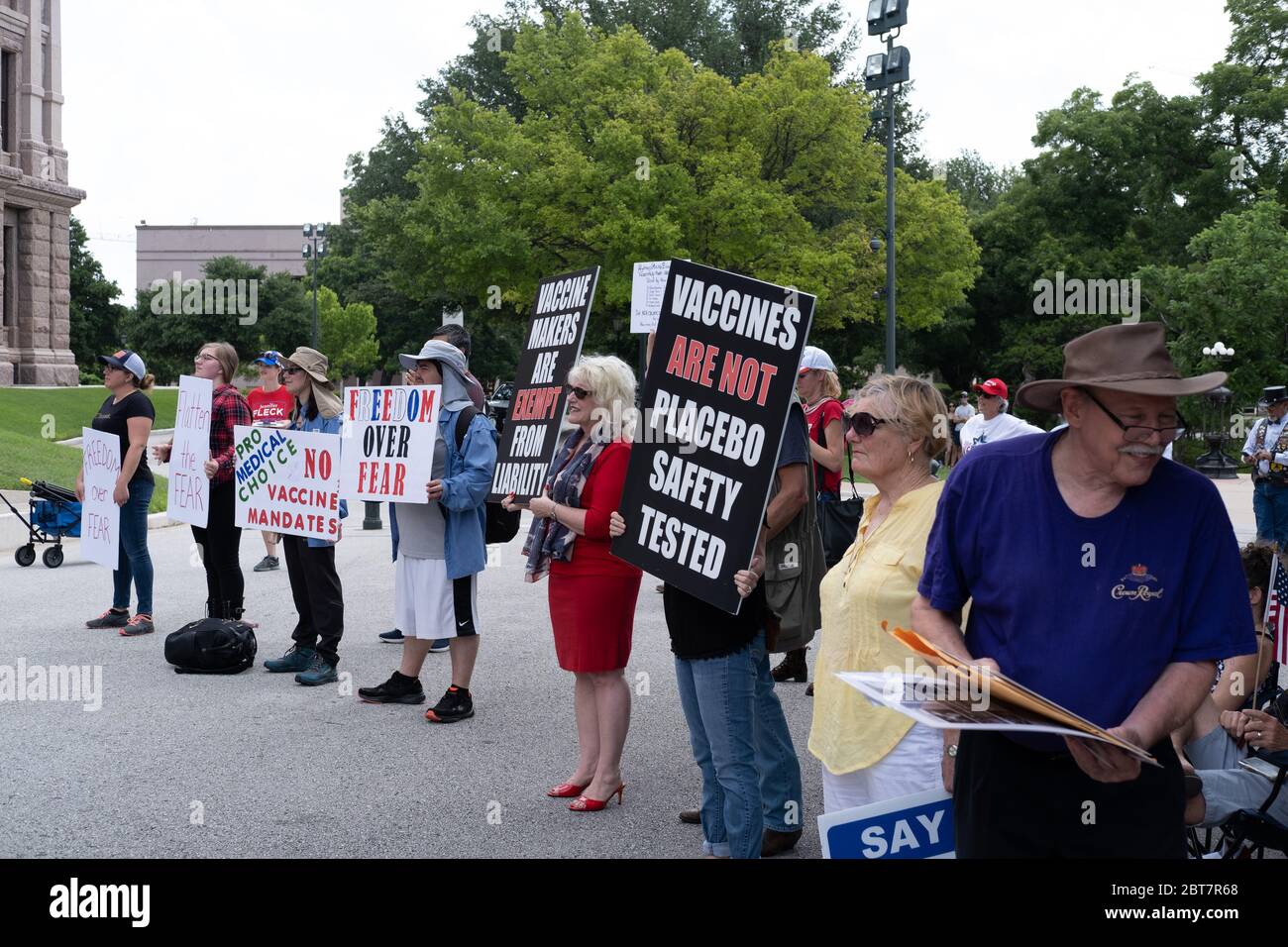 Austin, USA. 23 May, 2020. Many people in attendance of the Texas Freedom Rally held signs at the Capitol Saturday. Signs promotes sentiments such sas the right not to receive a vaccination to promoting the drug Hydroxychloroquine. JORDAN SIGLER/Alamy Live News Stock Photo