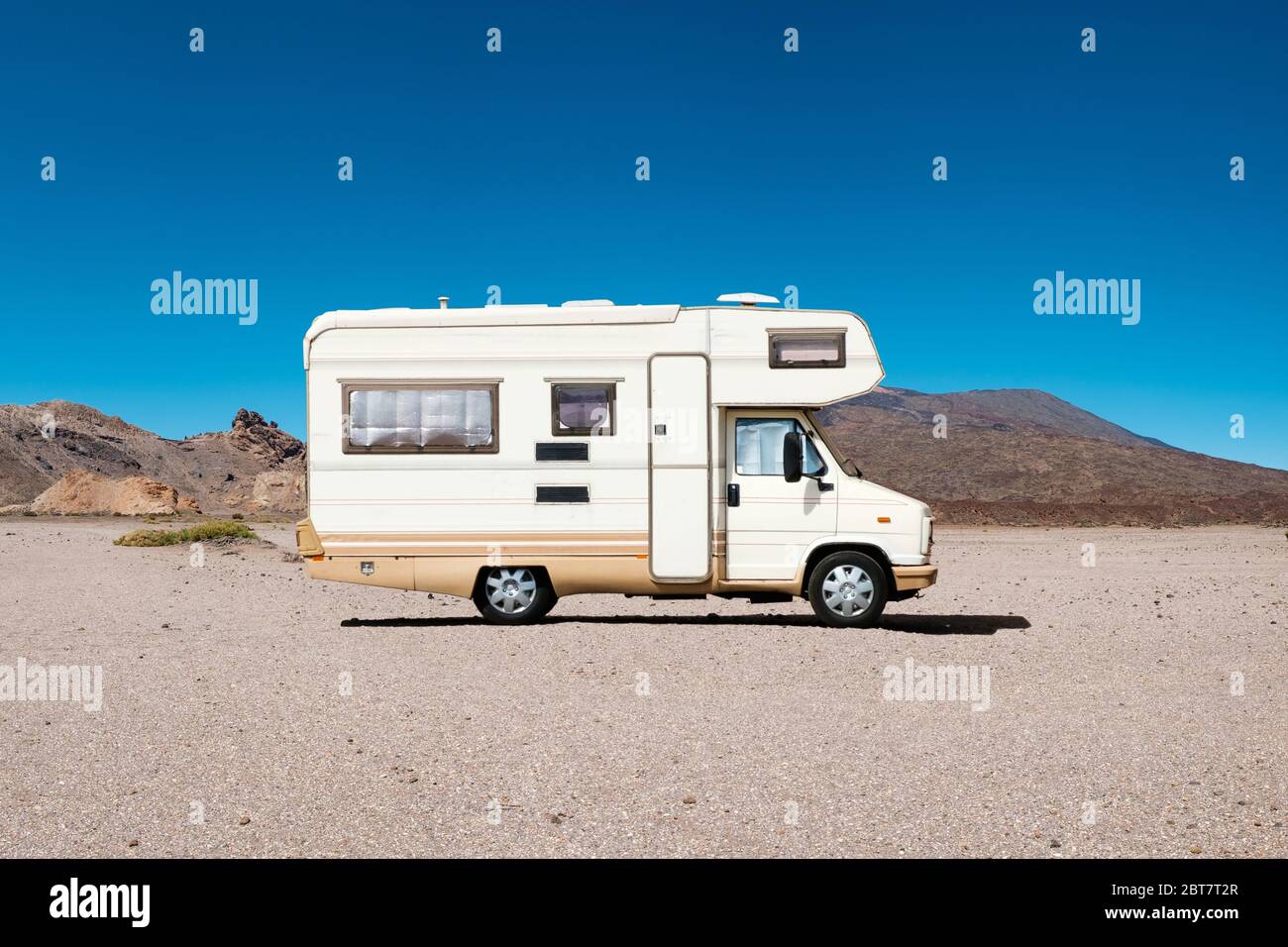 vintage camping bus, rv camper van in desert landscape Stock Photo