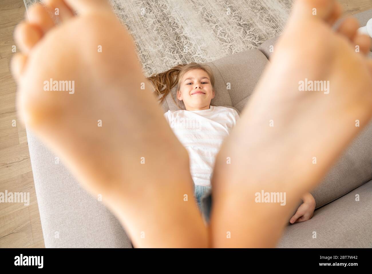 girl preteen soles Preteen girl lying on couch with her bare feet raising up high Stock Photo  - Alamy