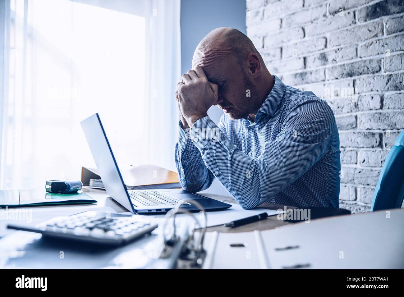 Worried confused man in shirt working on laptop computer Stock Photo ...